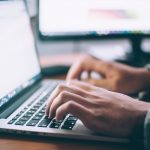 A man writing on his laptop