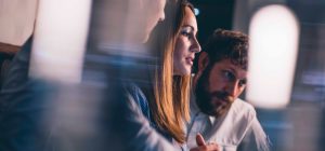 Woman and man looking at computer