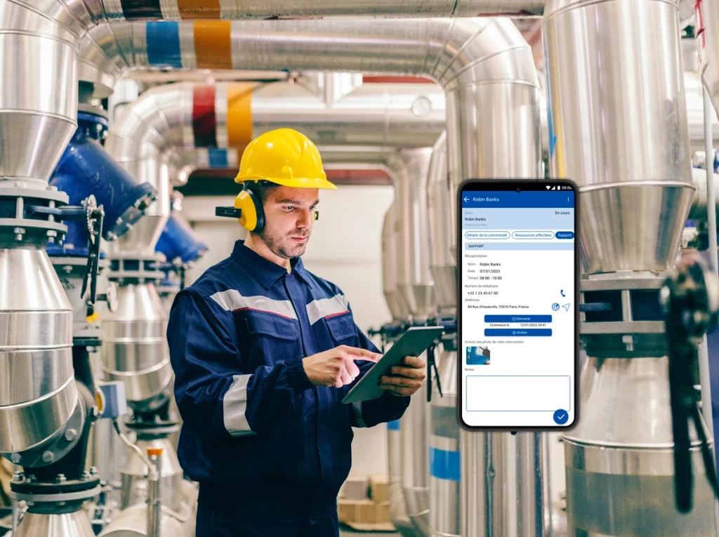 Technician working on an energy management system, using a smartphone to enter data on a mobile application.